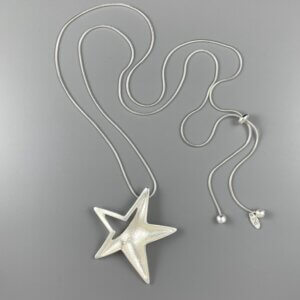 Large matt silver star pendant hanging from a silver snake chain