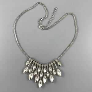 Short silver necklace with silver crystal ovals hanging from a silver snake chain
