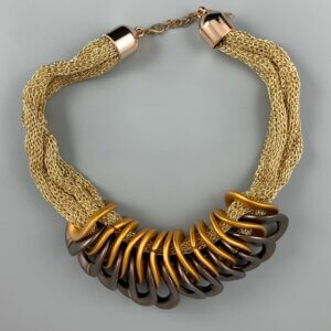 Gold mesh necklace with gold lobster clasp and a series of interlocking gold and dark gold twisted circle features