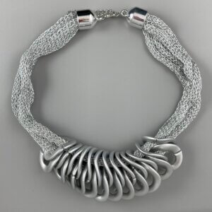 Silver mesh necklace with silver lobster clasp and a series of interlocking silver twisted circle features