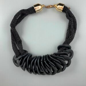 Black mesh necklace with gold lobster clasp and a series of interlocking black twisted circle features