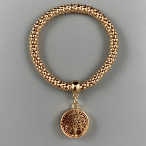 Vive Gold coloured tree of life charm hangs from a gold coloured elasticated bracelet